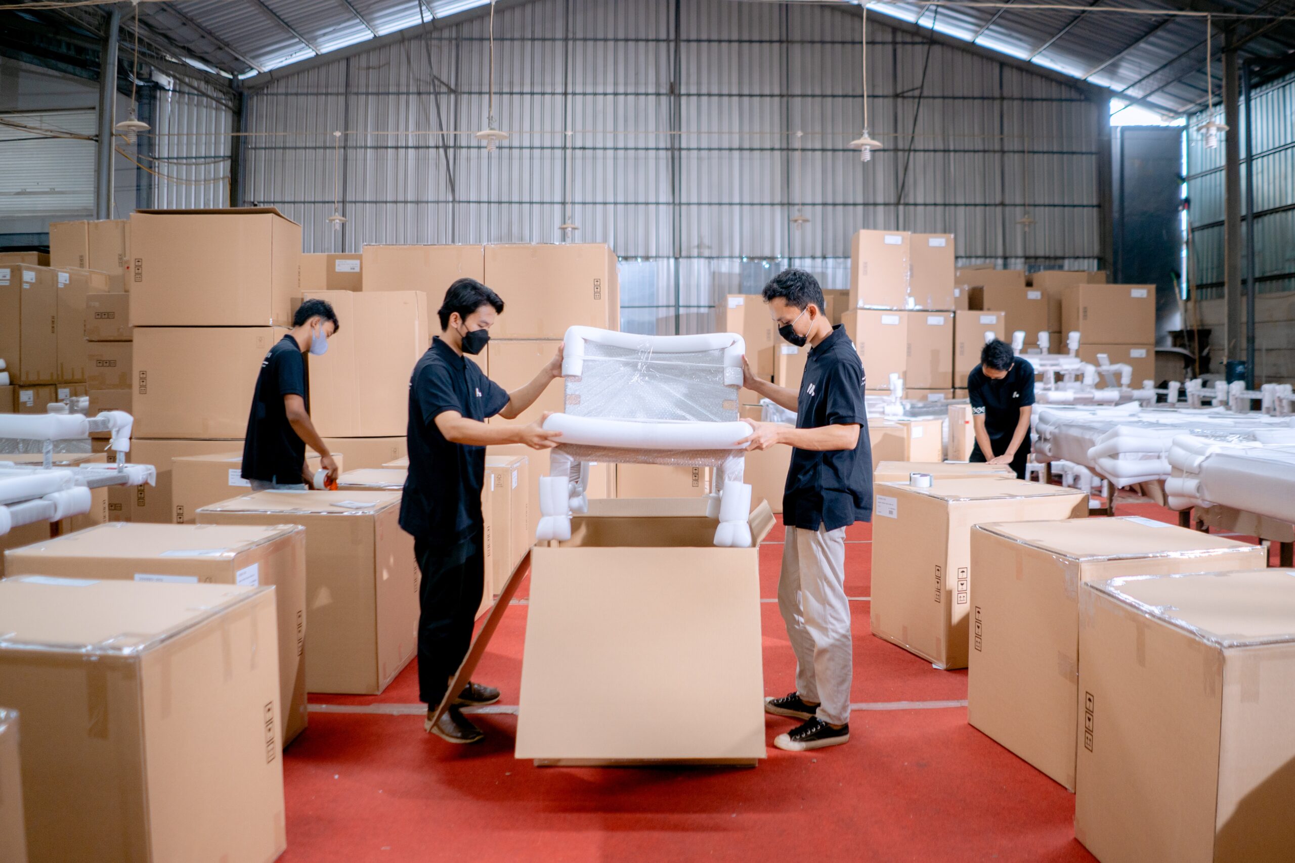Experienced warehouse workers carefully unpack and inspect recently received furniture items. With meticulous attention to detail, they handle a chair with utmost care, ensuring it is in pristine condition. Trust Diego Delivery for reliable and thorough inspection of your shipments for a seamless receiving process.